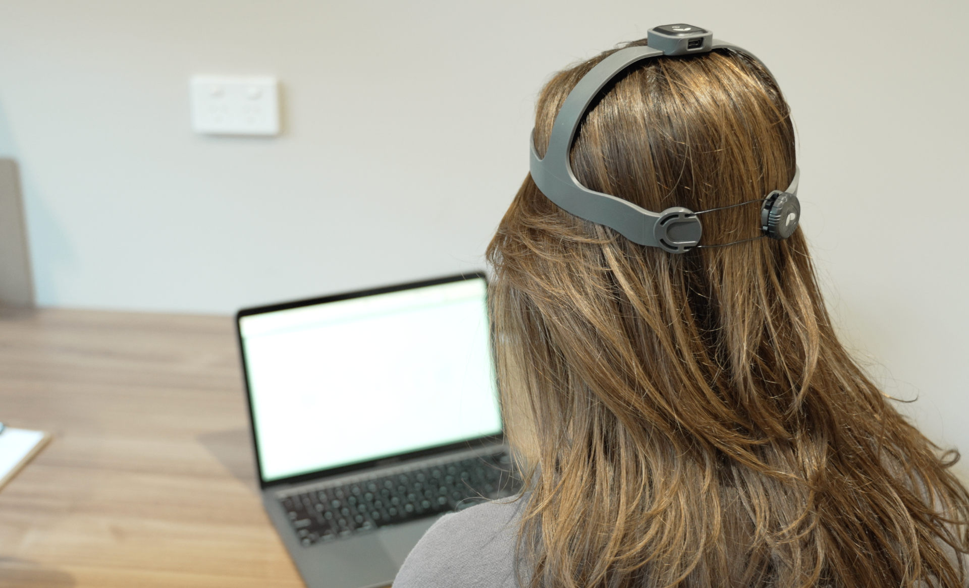 Patient performing a data-driven rehabilitation exercise with neck measurement equipment